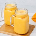An image capturing the vibrant hues of a freshly blended Easy Mango Smoothie, showcasing its smooth texture and inviting tropical appeal.