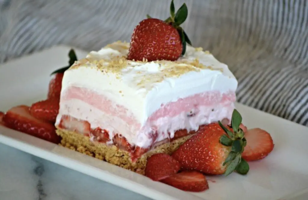 A heavenly slice of Strawberry Lasagna, showcasing layers of vibrant strawberries and creamy goodness.