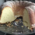 An inviting slice of Grandma's Sour Cream Pound Cake, adorned with a golden-brown crust and a velvety crumb, showcasing the essence of homemade perfection.