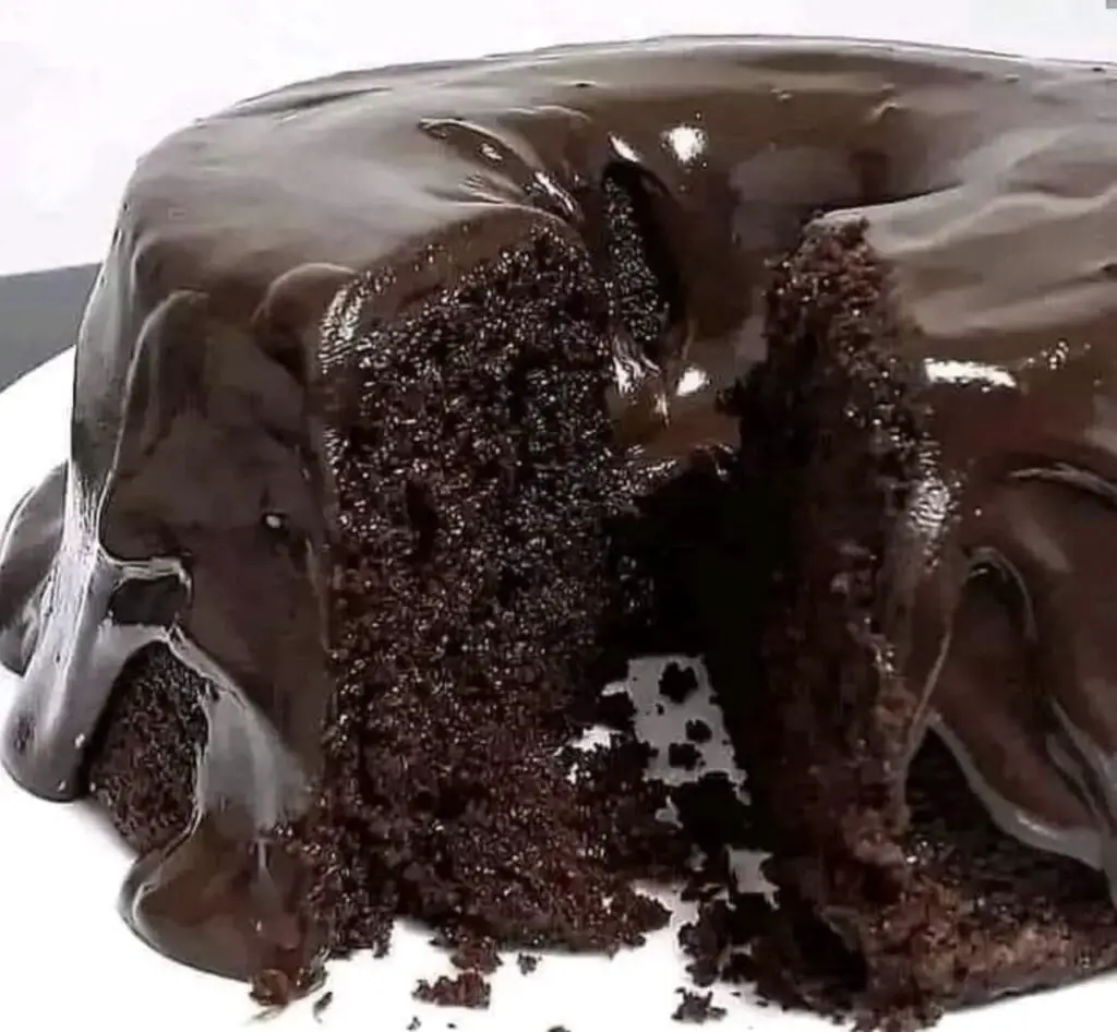 A mouthwatering image showcasing a beautifully frosted Chocolate Cake, its layers moist and rich, with a velvety chocolate frosting. This classic dessert is a visual and gastronomic delight.