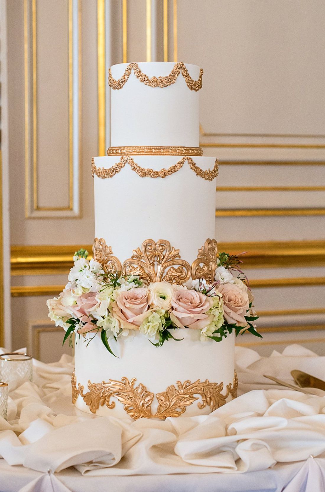 An ornately decorated Quinceañera cake adorned with floral motifs and delicate pearls, embodying tradition and celebration.