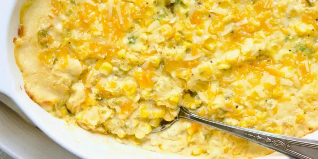 A golden-brown Corn Casserole, featuring a creamy and cheesy corn-filled mixture in a 9x13 inch baking dish. A comforting side dish ready to be served.