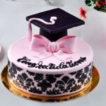 A visually stunning and decadent elegant graduation cake, adorned with whipped cream, fresh berries, and drizzles of caramel sauce—a perfect centerpiece for celebration.