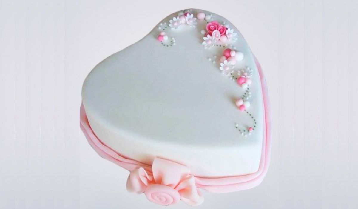 A beautifully decorated heart-shaped cake symbolizing love and creativity, adorned with vibrant frosting and edible flowers. Perfect for celebrations and sweet moments.