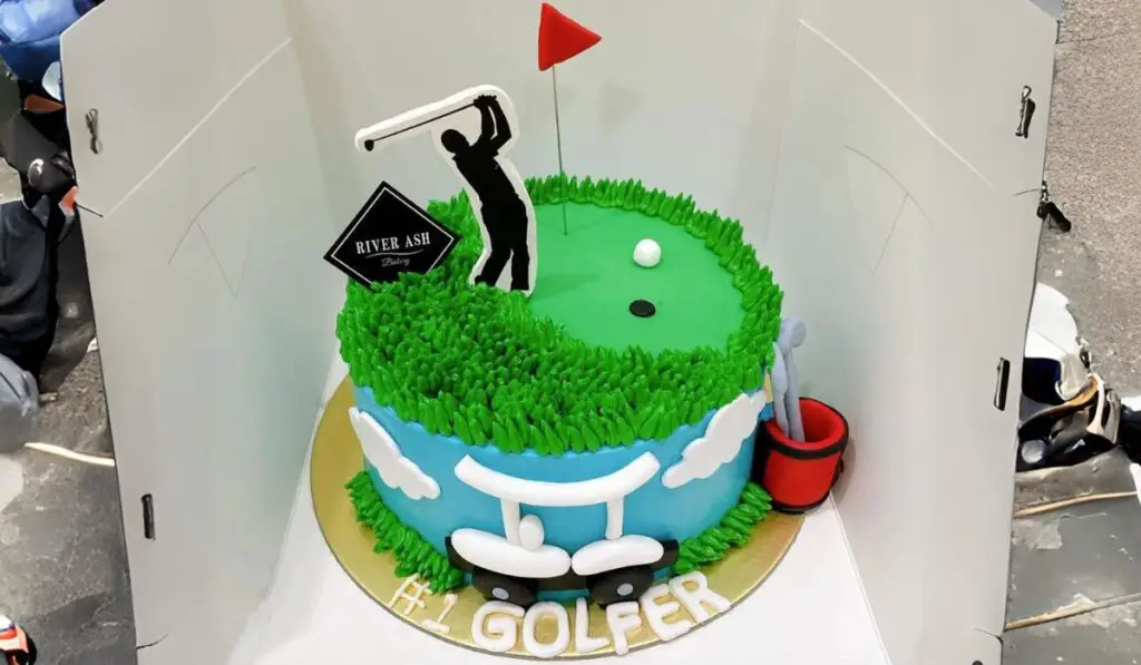 A decorated golf cake adorned with fondant golf clubs, balls, and a miniature golf course on top, showcasing creativity in golf-themed cake design.