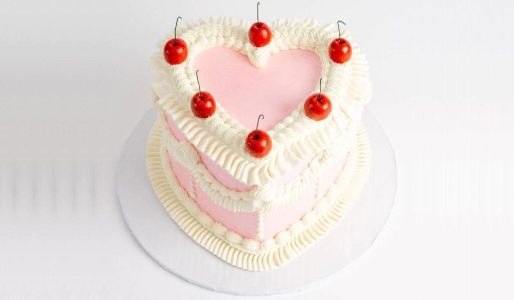 An exquisite vintage heart cake adorned with intricate designs, showcasing the timeless elegance of this nostalgic dessert.