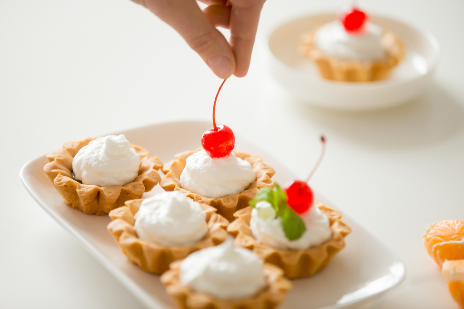 An image showcasing layers of Mini Charlotte Desserts, adorned with fresh berries and a velvety mascarpone filling.