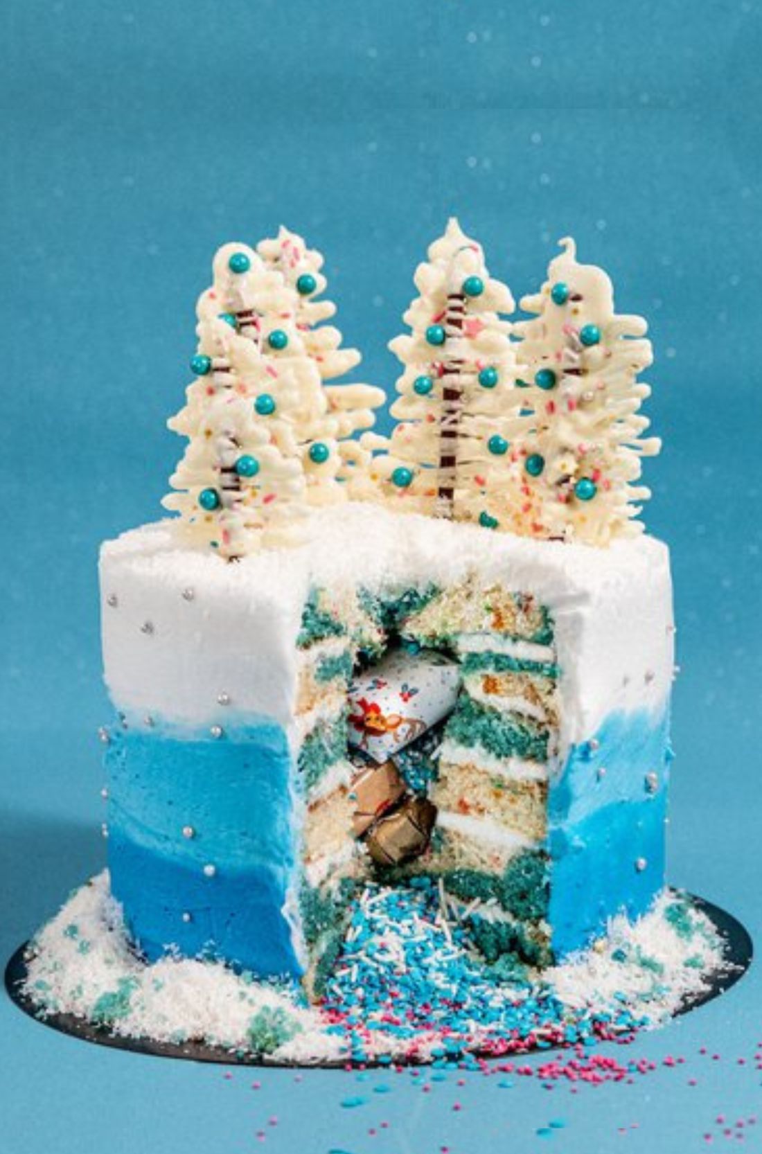An image of a three-tiered Winter Wonderland Cake decorated with snowflakes, shimmering icing, and a festive topper.