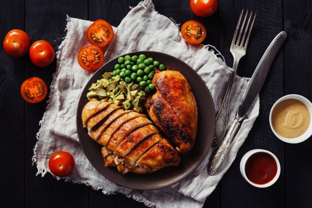 A perfectly cooked moist chicken breast served on a plate with garnish, showcasing the juicy and tender texture achieved through the techniques described in the guide.