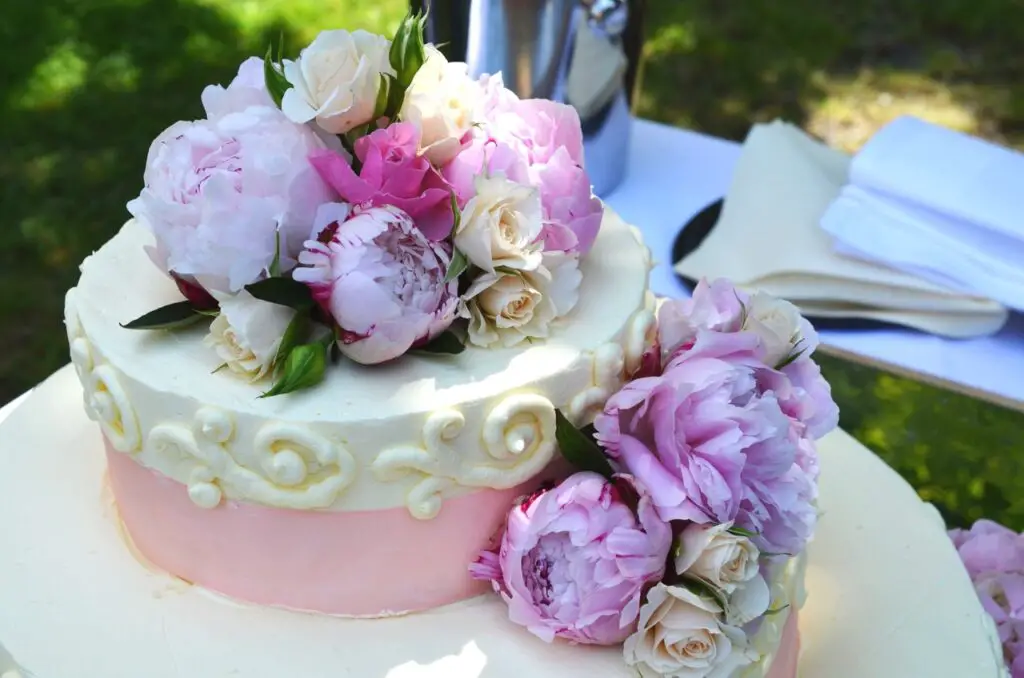 A beautifully decorated floral cake with vibrant edible flowers, showcasing the artistry of floral cake decoration